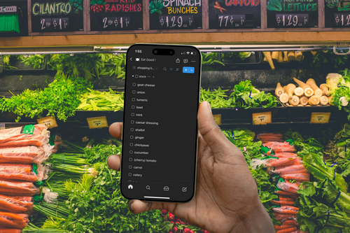 Point of view image of phone screen as user references the Notion Meal Plan and Grocery List Tool while in the produce section of a grocery store
